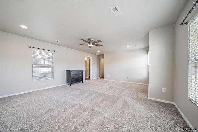 unfurnished living room featuring light carpet and ceiling fan