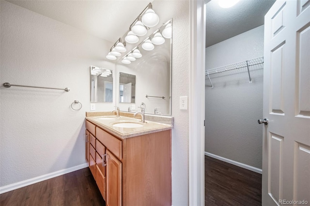 bathroom with vanity, hardwood / wood-style floors, and a textured ceiling