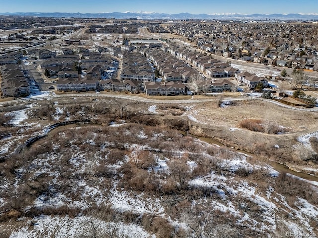 snowy aerial view with a mountain view