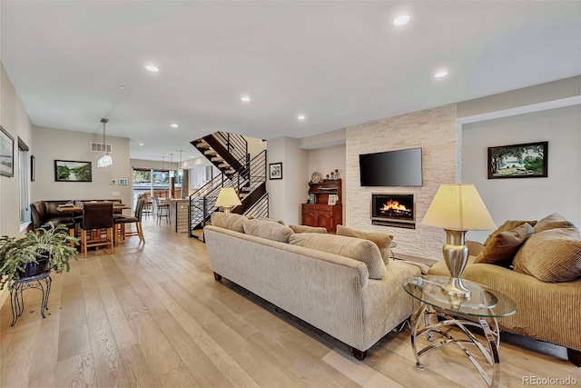 613 Iowa St, Golden, CO 80403 - living area featuring light wood-type flooring, visible vents, recessed lighting, stairs, and a fireplace