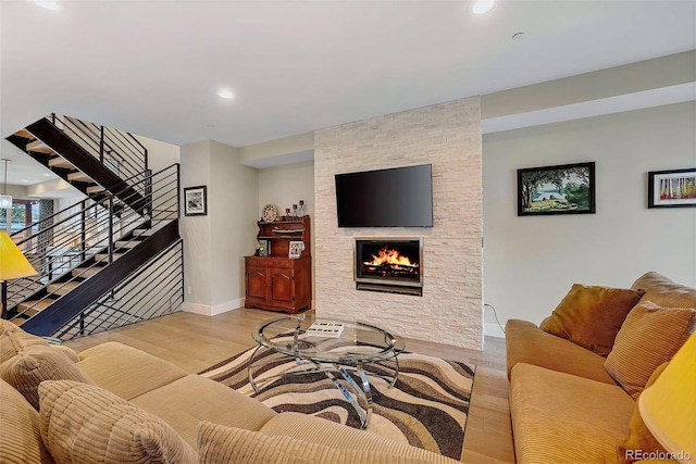 613 Iowa St, Golden, CO 80403 - living room featuring baseboards, recessed lighting, wood finished floors, stairway, and a stone fireplace
