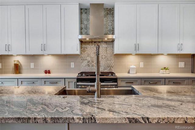 613 Iowa St, Golden, CO 80403 - kitchen featuring wall chimney range hood, range with two ovens, and light stone countertops