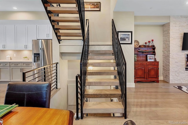613 Iowa St, Golden, CO 80403 - stairs featuring baseboards, wood finished floors, and recessed lighting
