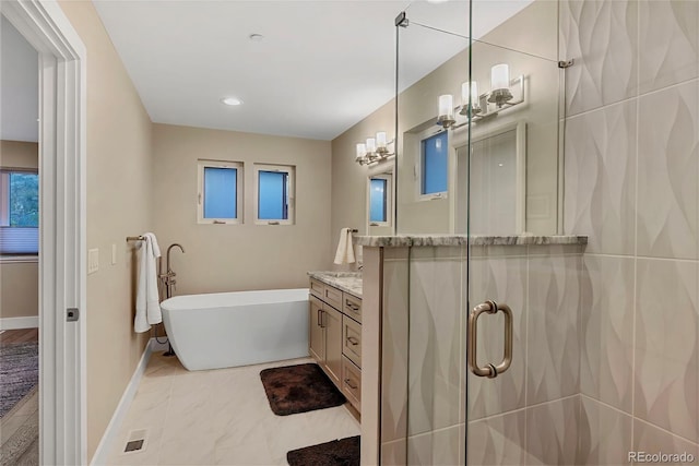 613 Iowa St, Golden, CO 80403 - bathroom featuring a stall shower, vanity, marble finish floor, a freestanding bath, and baseboards