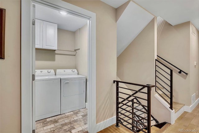 613 Iowa St, Golden, CO 80403 - washroom with washing machine and clothes dryer, baseboards, and cabinet space