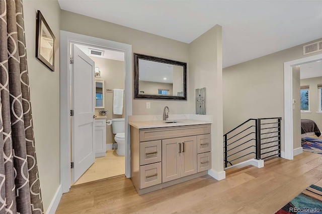 613 Iowa St, Golden, CO 80403 - full bathroom with baseboards, wood finished floors, visible vents, and toilet