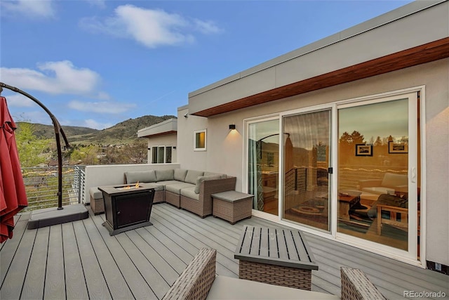 613 Iowa St, Golden, CO 80403 - wooden deck with a mountain view and an outdoor living space with a fire pit