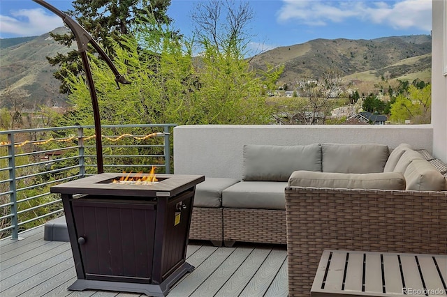 613 Iowa St, Golden, CO 80403 - wooden deck featuring a mountain view and an outdoor living space with a fire pit