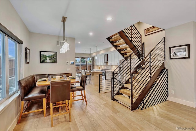 613 Iowa St, Golden, CO 80403 - dining space featuring recessed lighting, light wood-type flooring, visible vents, and stairs