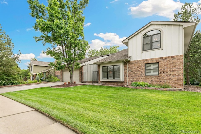 8474 E Otero Cir, Centennial, CO 80112 - view of front of home with board and batten siding, brick siding, driveway, and a front lawn
