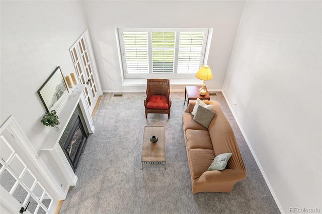 8474 E Otero Cir, Centennial, CO 80112 - carpeted living area featuring baseboards and a glass covered fireplace