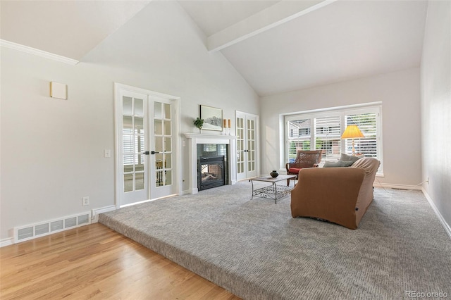 8474 E Otero Cir, Centennial, CO 80112 - living area featuring french doors, high vaulted ceiling, a fireplace, beamed ceiling, and baseboards