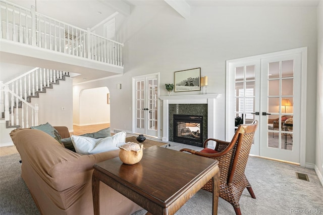 8474 E Otero Cir, Centennial, CO 80112 - living room with french doors, a premium fireplace, high vaulted ceiling, stairway, and beam ceiling