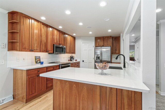 8474 E Otero Cir, Centennial, CO 80112 - kitchen featuring stainless steel appliances, a sink, tasteful backsplash, a peninsula, and recessed lighting