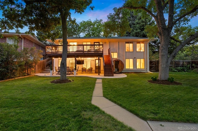 13693 W Utah Cir, Lakewood, CO 80228 - back of property with a wooden deck, a patio area, and stairs