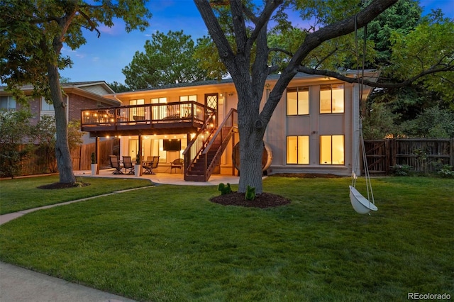 13693 W Utah Cir, Lakewood, CO 80228 - back of property with a wooden deck, a patio, a fenced backyard, and stairway