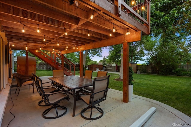13693 W Utah Cir, Lakewood, CO 80228 - fenced backyard with stairs, outdoor dining area, a patio, and a storage unit