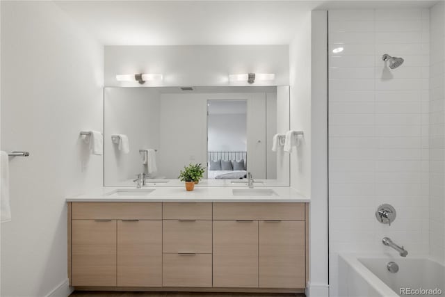 bathroom featuring vanity and tiled shower / bath combo