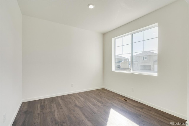 unfurnished room with hardwood / wood-style flooring