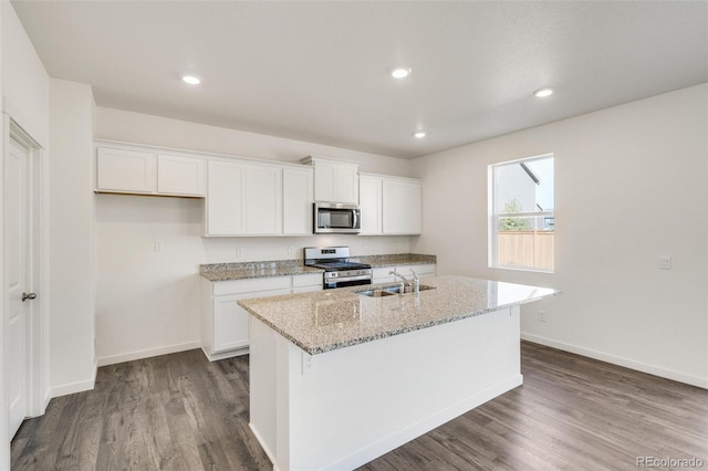 kitchen featuring a kitchen island with sink, sink, white cabinets, and appliances with stainless steel finishes