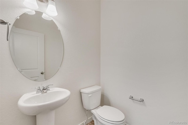 bathroom featuring sink and toilet