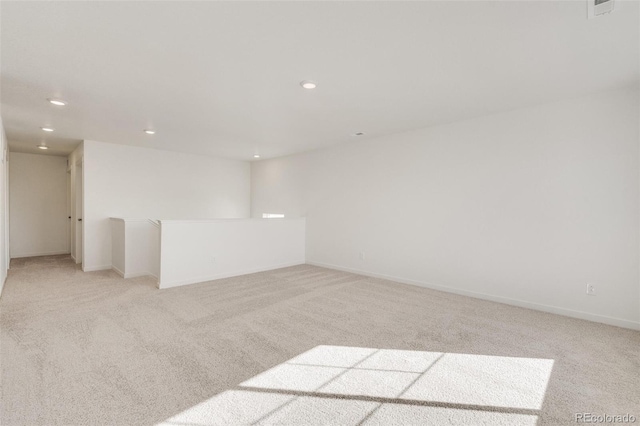 empty room featuring light carpet