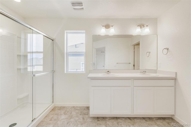 bathroom with vanity and a shower with shower door