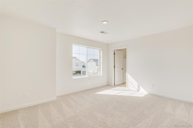 unfurnished room with light colored carpet