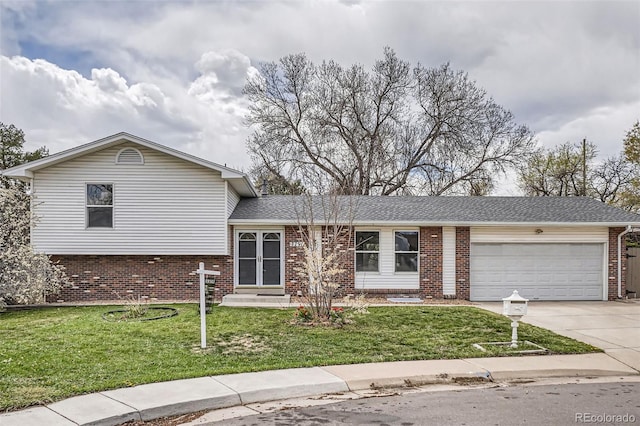 tri-level home with brick siding, a front yard, and a garage