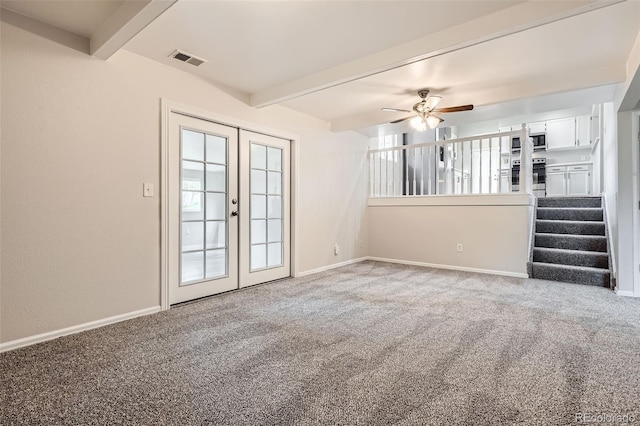 spare room with visible vents, a ceiling fan, french doors, beam ceiling, and carpet flooring