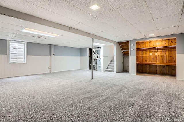 below grade area featuring a drop ceiling and carpet
