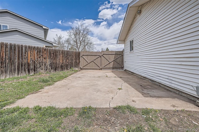 view of patio with a gate and fence