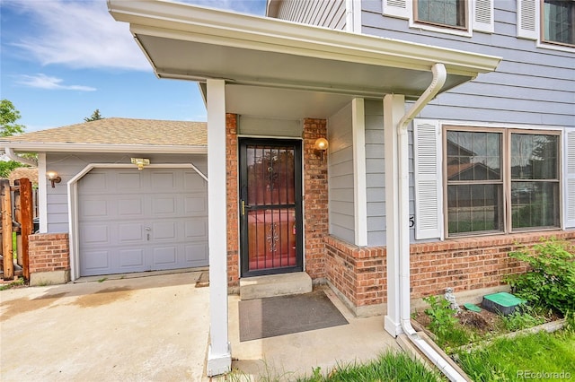 5275 Cody St, Arvada, CO 80002 - entrance to property with brick siding, a garage, and driveway