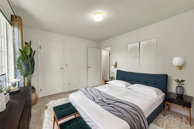 5275 Cody St, Arvada, CO 80002 - bedroom featuring light carpet, multiple windows, and a textured ceiling