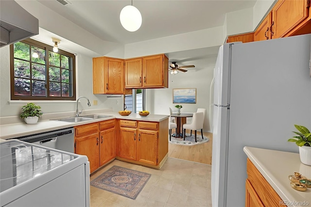 5275 Cody St, Arvada, CO 80002 - kitchen with white appliances, a peninsula, light countertops, a ceiling fan, and brown cabinets