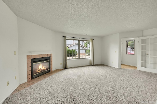 5275 Cody St, Arvada, CO 80002 - unfurnished living room featuring a fireplace, plenty of natural light, a textured ceiling, and carpet