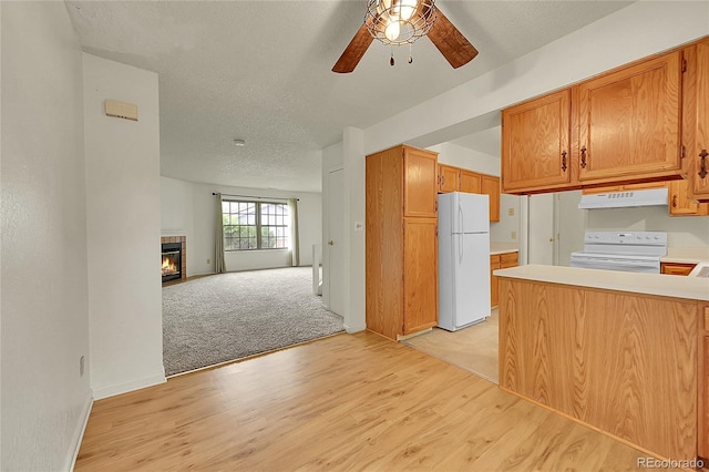 5275 Cody St, Arvada, CO 80002 - kitchen featuring white appliances, under cabinet range hood, ceiling fan, light wood-type flooring, and light countertops