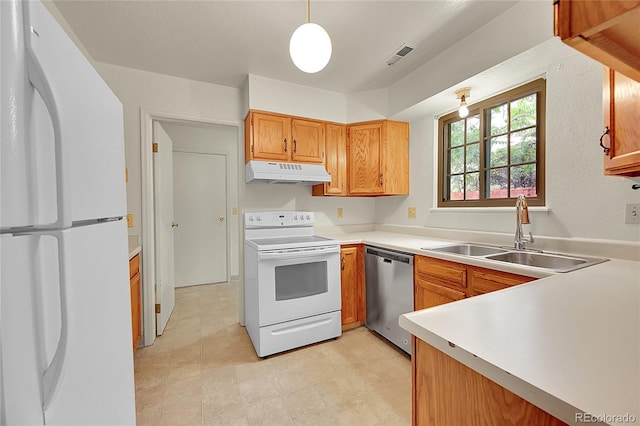 5275 Cody St, Arvada, CO 80002 - kitchen with white appliances, under cabinet range hood, light countertops, brown cabinets, and pendant lighting