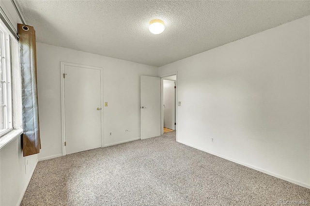 5275 Cody St, Arvada, CO 80002 - unfurnished bedroom featuring a textured ceiling and carpet flooring