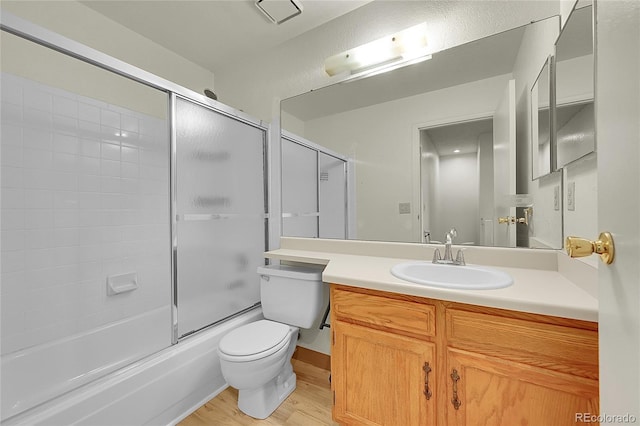 5275 Cody St, Arvada, CO 80002 - bathroom featuring wood finished floors, vanity, and combined bath / shower with glass door