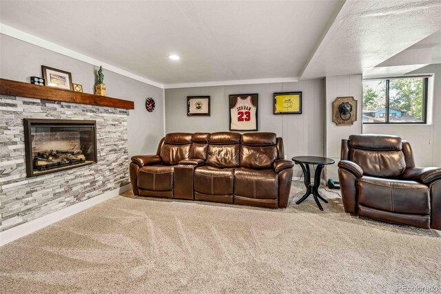 living room featuring a fireplace, a textured ceiling, crown molding, and carpet floors