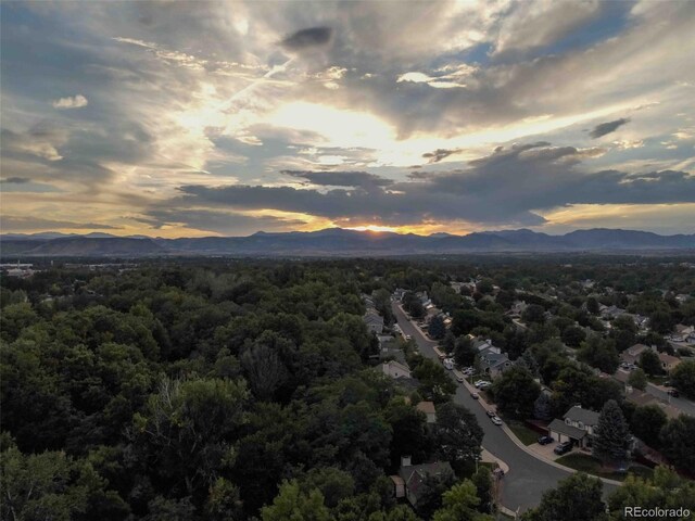 aerial view at dusk featuring a mountain view