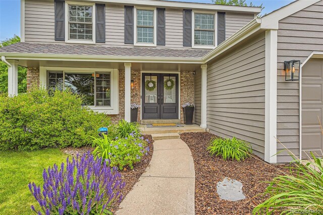 7708 S Krameria Ct, Centennial, CO 80112 - view of exterior entry featuring a porch and a garage
