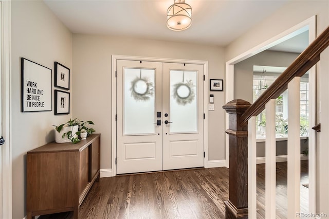 7708 S Krameria Ct, Centennial, CO 80112 - foyer entrance featuring dark wood-style floors, french doors, baseboards, and a chandelier