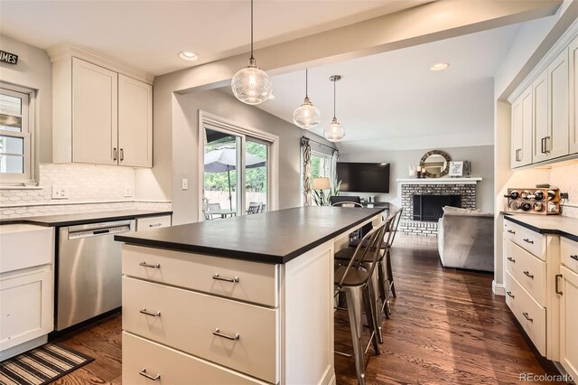 7708 S Krameria Ct, Centennial, CO 80112 - kitchen with dishwasher, dark countertops, dark wood-type flooring, open floor plan, and recessed lighting