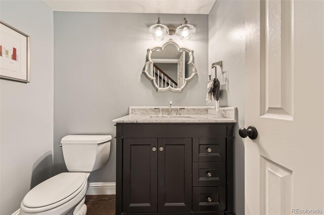 7708 S Krameria Ct, Centennial, CO 80112 - half bath featuring toilet, vanity, and baseboards