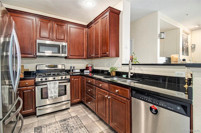 kitchen featuring light tile patterned flooring, appliances with stainless steel finishes, a sink, and recessed lighting