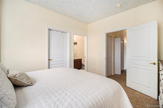 carpeted bedroom featuring ensuite bathroom