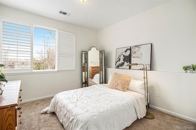 bedroom with visible vents, carpet, and baseboards