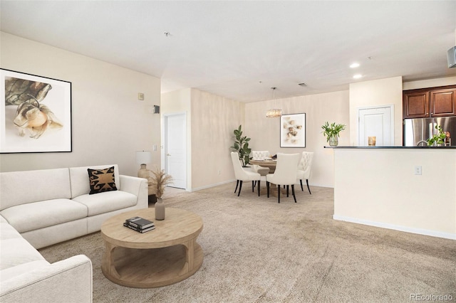 living room with recessed lighting, baseboards, and light carpet